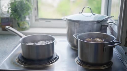 Pots of Boiling Water on Kitchen Stove Top