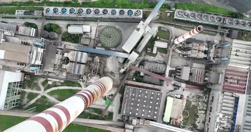 Aerial Drone Shot of Coal Power Plant with Two High Cooling Towers Next to Blue River