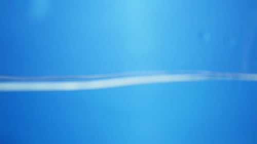 Water splashing against a surface with transparent bubbles floating, symbolizing freshness, cleanlin