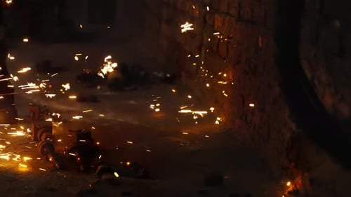 Intense Welding Sparks Scatter Across an Industrial Workshop Illuminating a Brick Wall Scattered