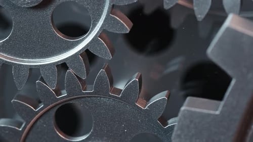 Close Up of Interlocking Metal Gears Turning