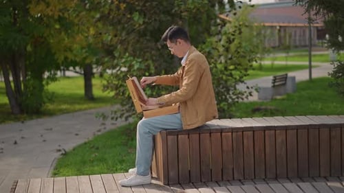 Teenage Student Capturing City Park Scene with Pencil Youthful Individual Meticulously Illustrating