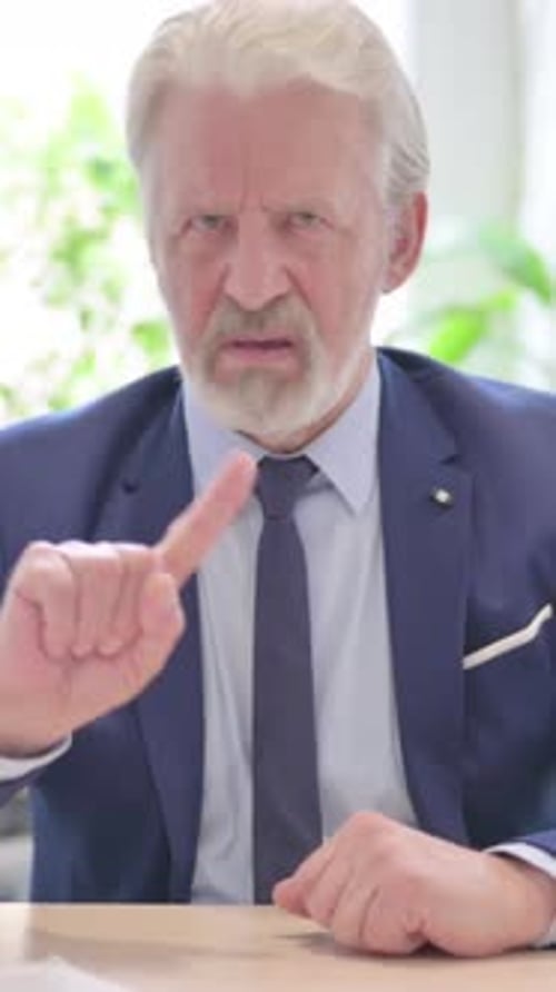 Stern Senior Man Gesturing No With Finger