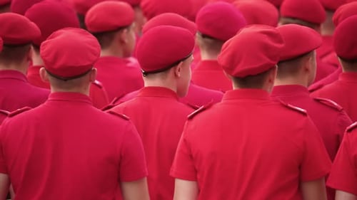 Crowd of People Marching in Red Uniforms