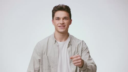 Smiling Man with Curly Hair Poses in Studio