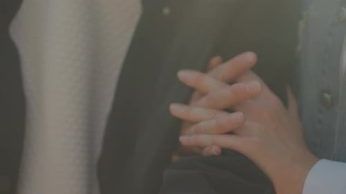 Closeup Hands Entwined Over Jacket Intimate Gesture Symbolizing Commitment and Support Subtle