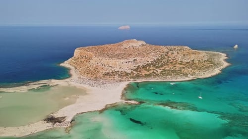 Aerial view of a serene island with turquoise waters and sandy beaches