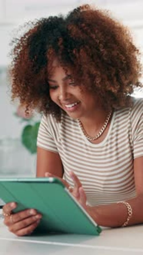 Smiling Woman Using Tablet Device at Home