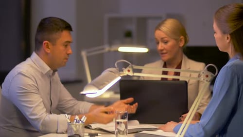 Late night office stress coworkers arguing over deadline documents and laptop