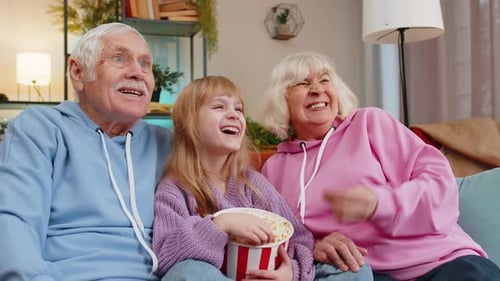 Grandparents Watching TV with Grandchild