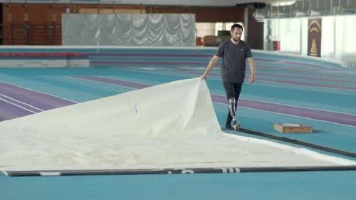 Athlete with Prosthetic Leg Prepares Long Jump Pit