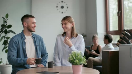 Office Co-Workers with Mugs Talk at Meeting Room. Teamwork of Friendly Man