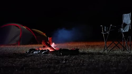 Campfire with Camping Chair and Tent at Night