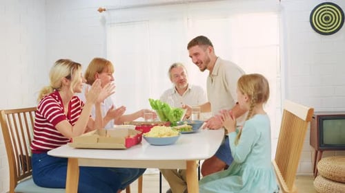 Family Celebrates Together at Dining Table