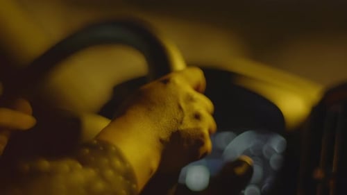 Female Person With Black Curly Hair Driving Car In The City At Night Traffic