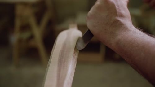 Close-Up of Hand Carving Wood with Chisel, Showcasing Craftsmanship and Detail