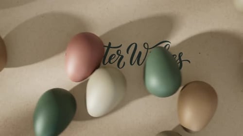 Decorative Easter Wishes Text with Rolling Eggs