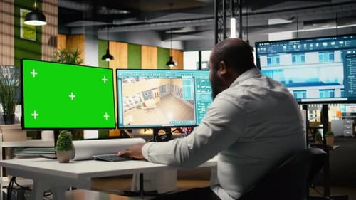Black Engineer Works on Floor Plan Design with a Mockup Display