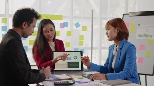 Business Team Collaborating on Data Analysis in Office