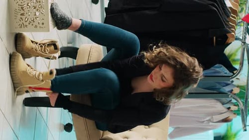 Vertical Video Elegant Woman Trying on a Pair of Shoes in Department Store