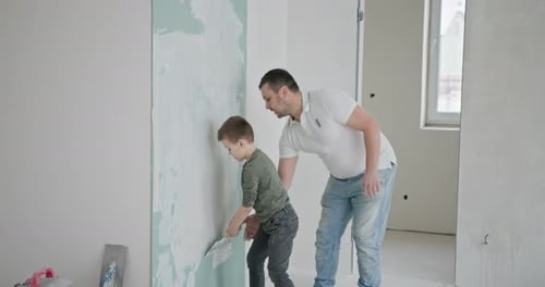 Father and Son Plastering Together