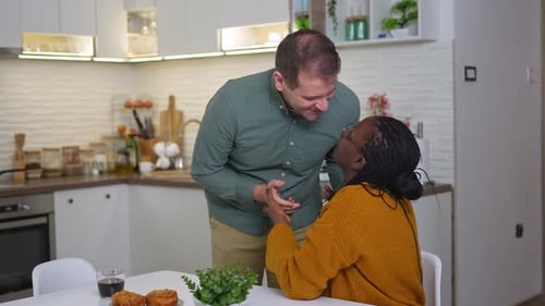 Loving Couple Embracing in Modern Kitchen