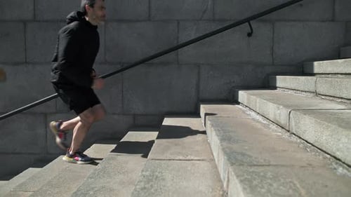 Man Jogging up Concrete Urban Steps