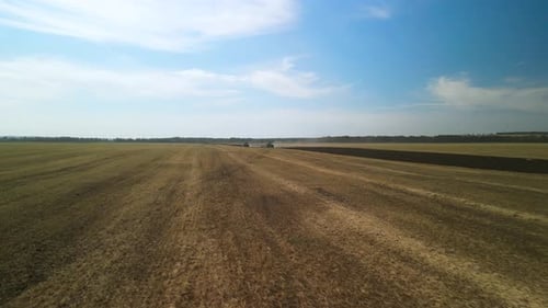 Tractors plowing the field in Ukraine