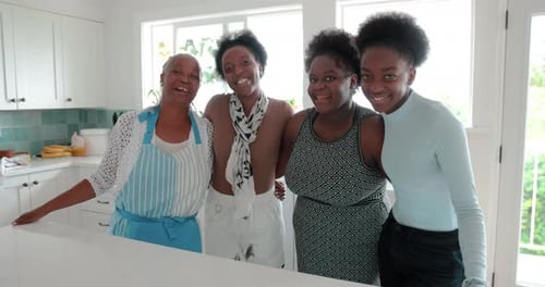 Four Smiling Women Gathered in a Bright Kitchen