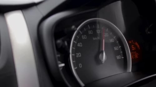 Fast Driving car a speedometer 100 plus kilometers per hour display front passenger view point close