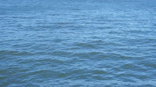 Aerial flight over the turquoise ocean waves on a beautiful summer morning