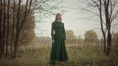 Model posing in green dress for nature fashion photoshoot