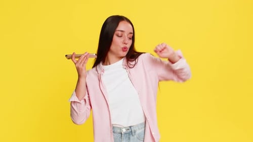 Cheerful Woman Dancing and Lip-Syncing with Smartphone