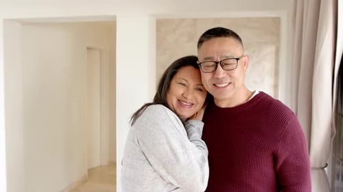 Smiling Couple Embracing Indoors