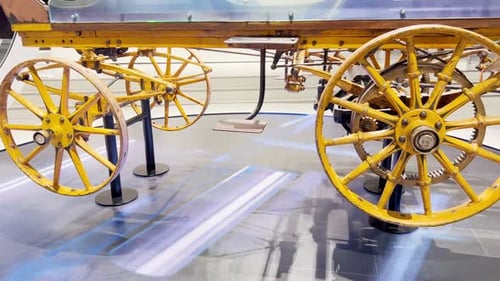 A Close Up of a Wagon with Yellow Wheels on a Table