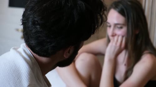 couple sad and frustrated in bed thinking of breaking up