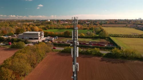 Cinematic Shot Of A Telecommunication Tower At The Field In The Country Outskirts During Autumn. aer