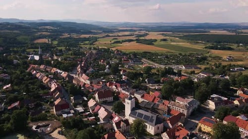 Drone Flight Over Countrysude Area with Small Town and Mountains