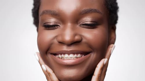 Smiling Young Woman's Beautiful Face with Braces