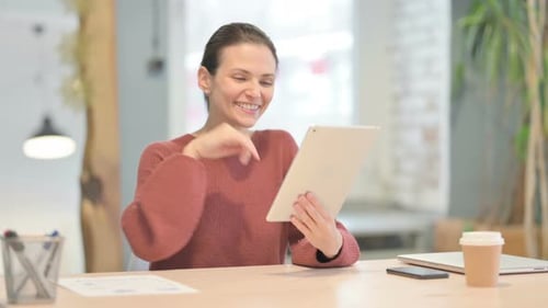Woman Video Calling on Tablet in Office