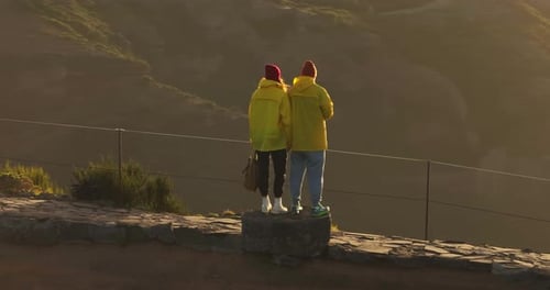 Couple Admiring Mountainous View During Golden Hour