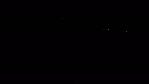 Multiple fireworks exploding at the same time at a fireworks display while I drone captures them.