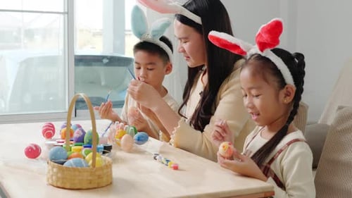 Mother and Children Painting Festive Easter Eggs