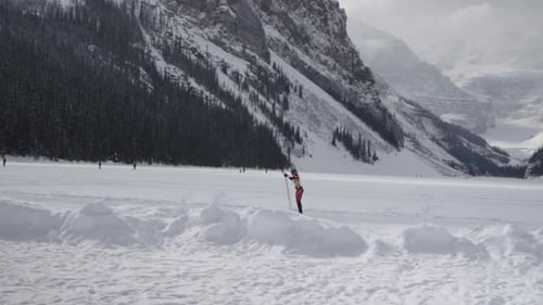 skier accelerates during competitions on frozen lake luise in canadian rockies
