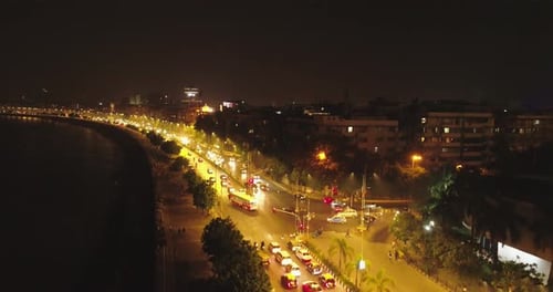 An aerial view with cinematic drone movement of the iconic Marine Drive nightlife with Air India and