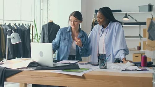 Fashion Designers Collaborating in Modern Studio
