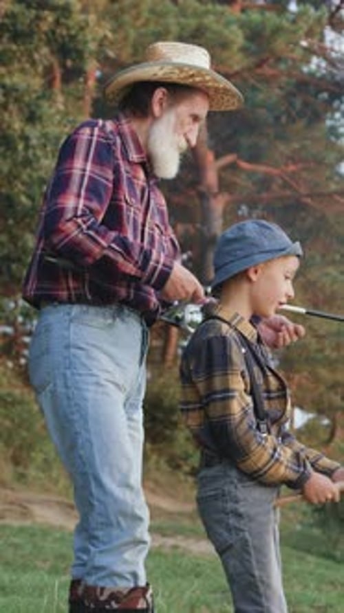 Side View of Likable Confident Experienced Mature Greybearded Fishman in Straw Hat Which Standing