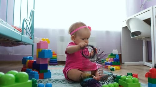 Baby Playing with Toys on Floor Indoors