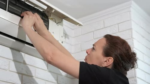 Woman Cleaning Aircon Filters