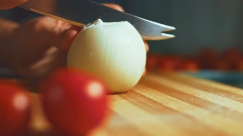 Person Cutting White Onion on Cutting Board